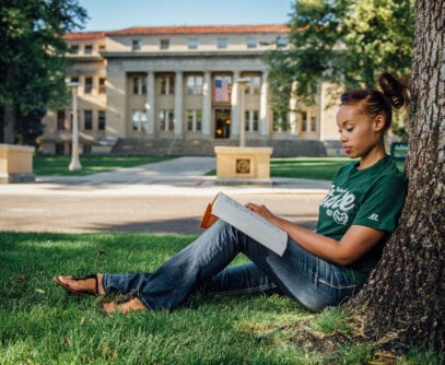 Black female CSU student studying outdoors