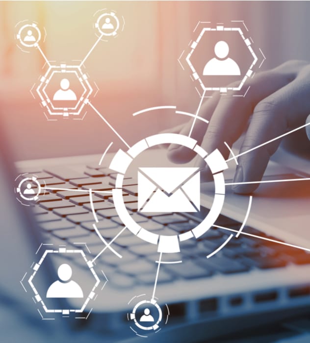 hands typing on laptop with a graphic overlay of an envelope in the center with lines going out to people icons signifying emails being sent to people