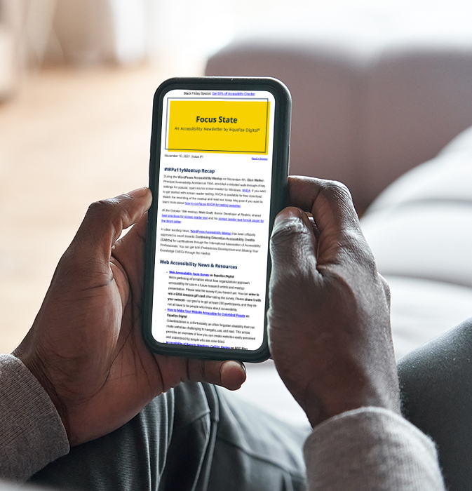 Black or African American man holding smart phone and reading the Focus State accessibility email newsletter