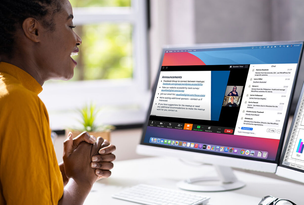 Black woman watching WordPress Accessibility Meetup on Zoom and smiling.