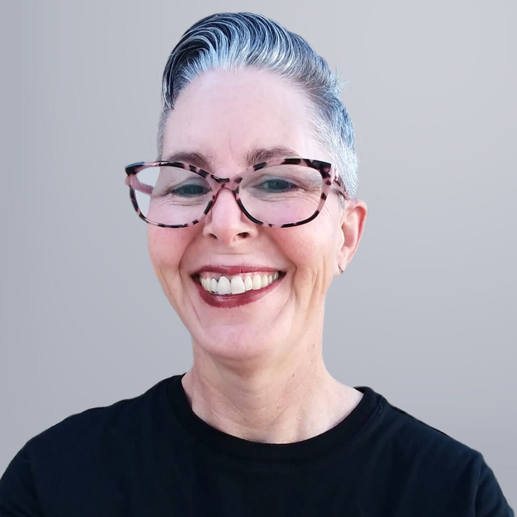 Chris Ford is a white woman with short gray hair and tortoise-shell glasses.