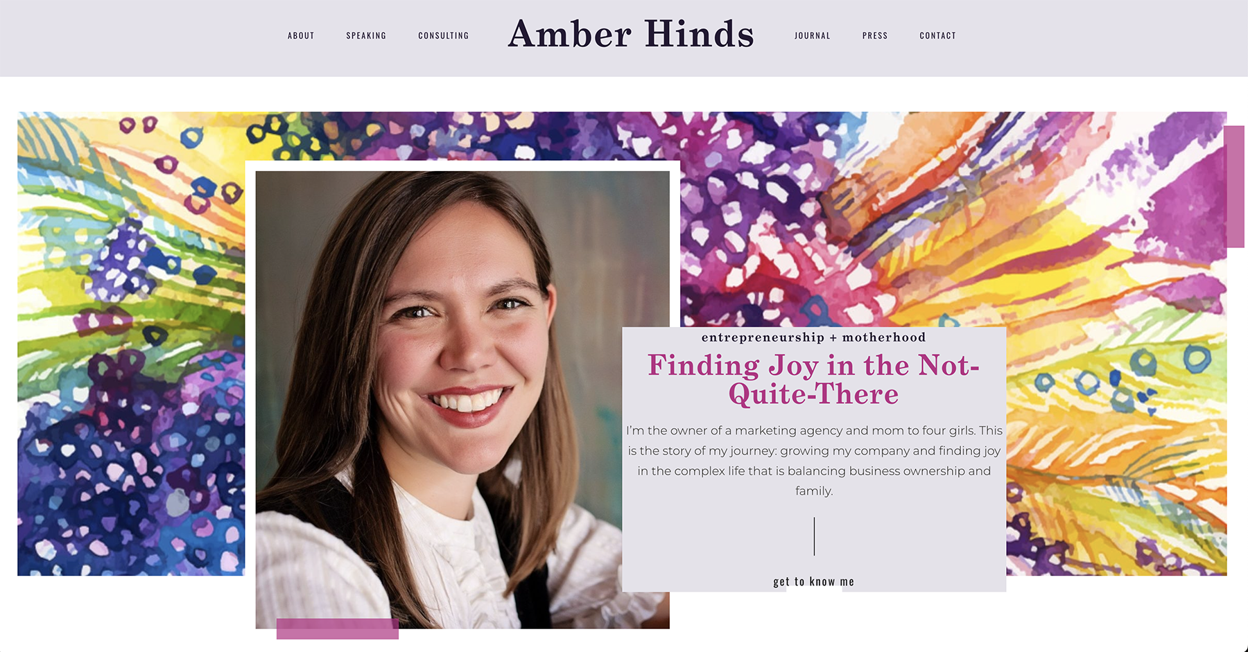 Amber's old website design included a split navigation menu on either side of her name, centered. The hero section had a headshot partially overlapping with a content container.