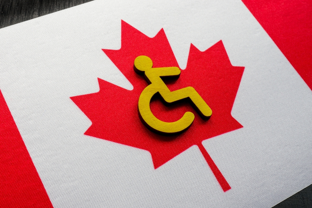 A Canadian flag with a disability icon over laid on it to illustrate the Accessible Canada Act.