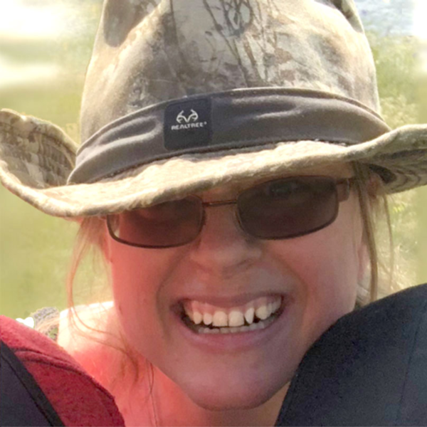 Diane, wearing her favorite hat, smiling and happy on a beautiful sunny day.