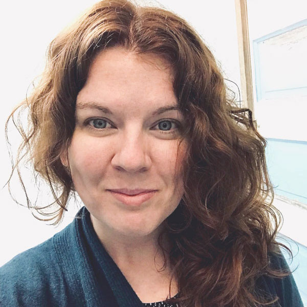 A pale skinned white woman with long auburn hair